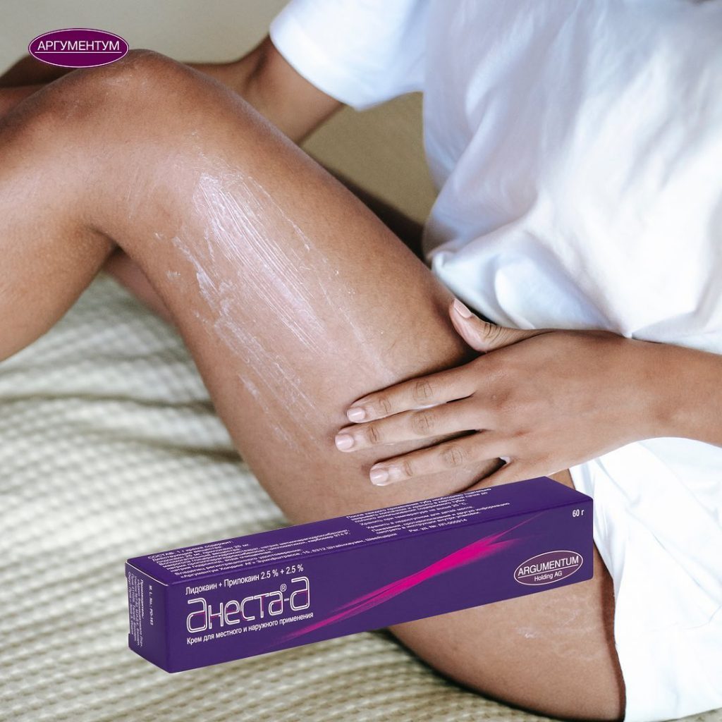 Тюбик Анеста-А на фоне женских ног — обезболивание перед эпиляцией